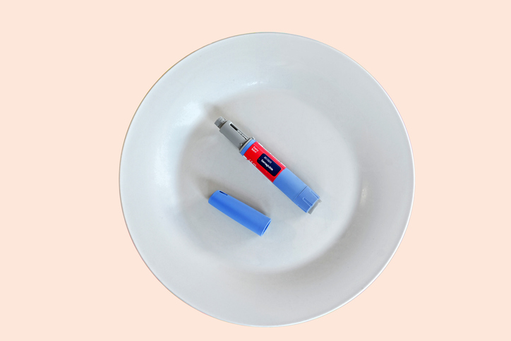 Semaglutide injecting pen with lid on a white plate