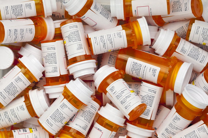Dozens of orange prescription bottles with white labels