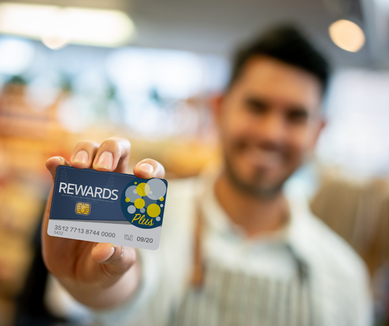 Man holding rewards card